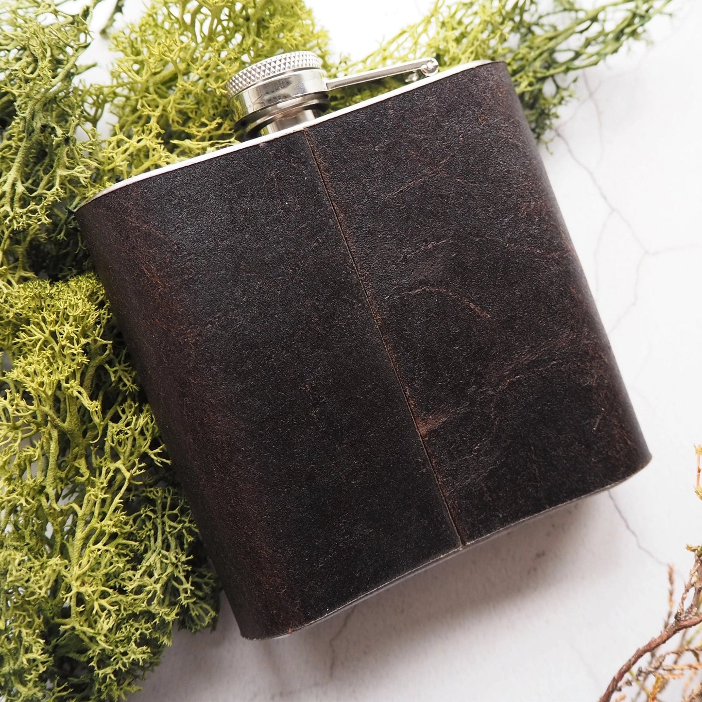 Posterior view of the monogrammed hip flask.