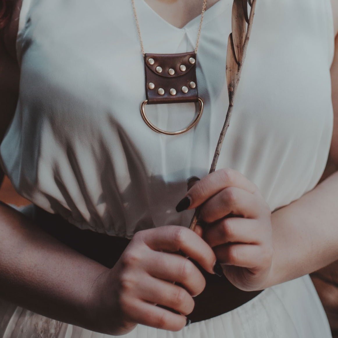 This lunar cycle necklace is the perfect addition to your outfit.