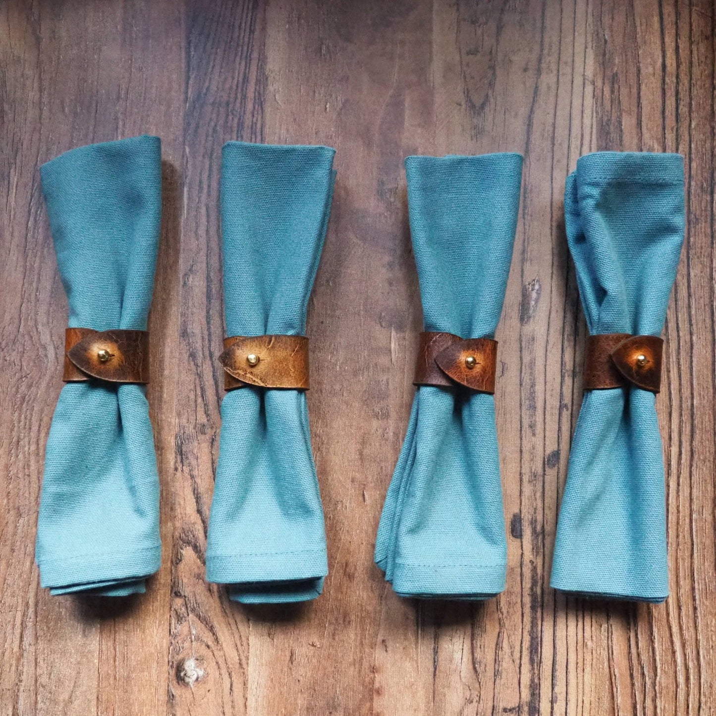 The Luxury Napkin Ring offerings from HÔRD beautifully and gracefully holding 4 blue napkins.