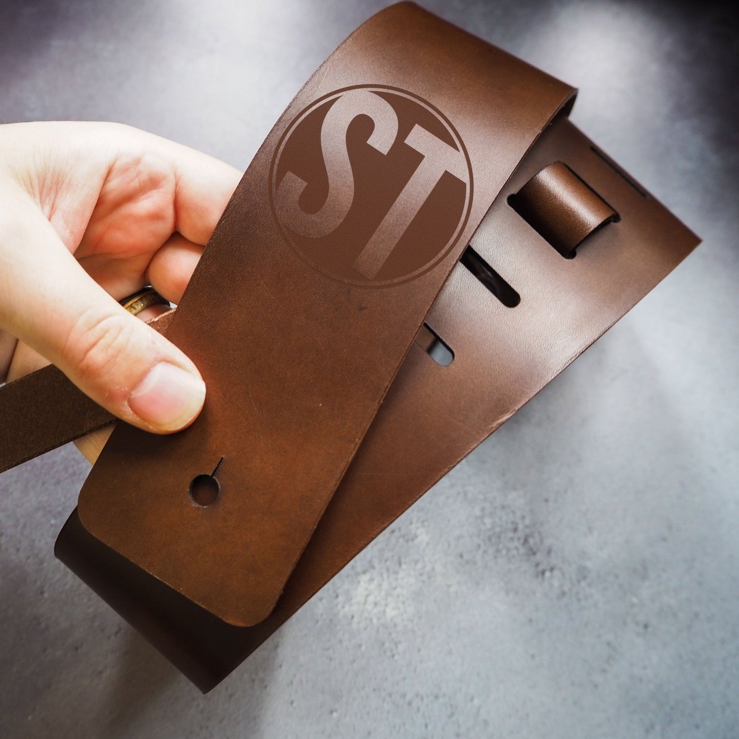 Close-up on the personalised logo on the Thick Leather Guitar Strap with Custom Logo by HÔRD.