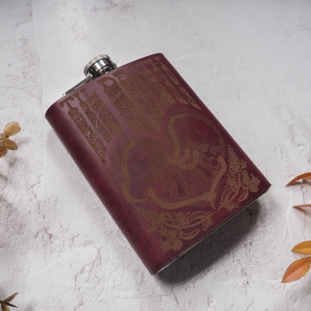 
                  
                    Retro wedding hip flask with psychedelic skull illustration and snake motifs.
                  
                