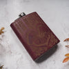 Retro wedding hip flask with psychedelic skull illustration and snake motifs.
