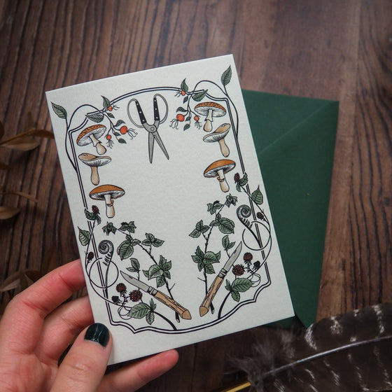 Gardening and Foraging Greeting Card - Featuring a whimsical foraging tools amidst a floral cottagecore frame