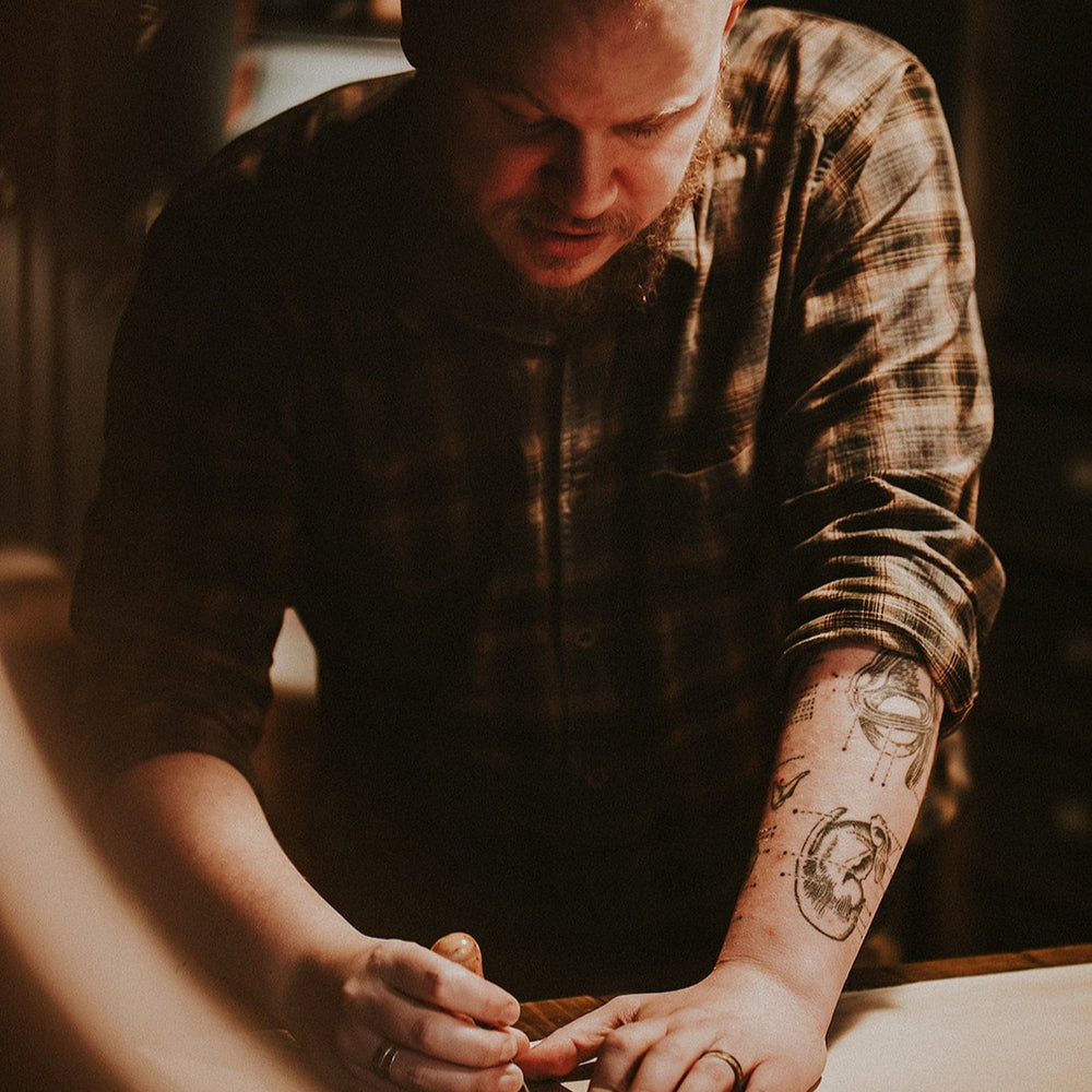 Jason working on a large hide of leather