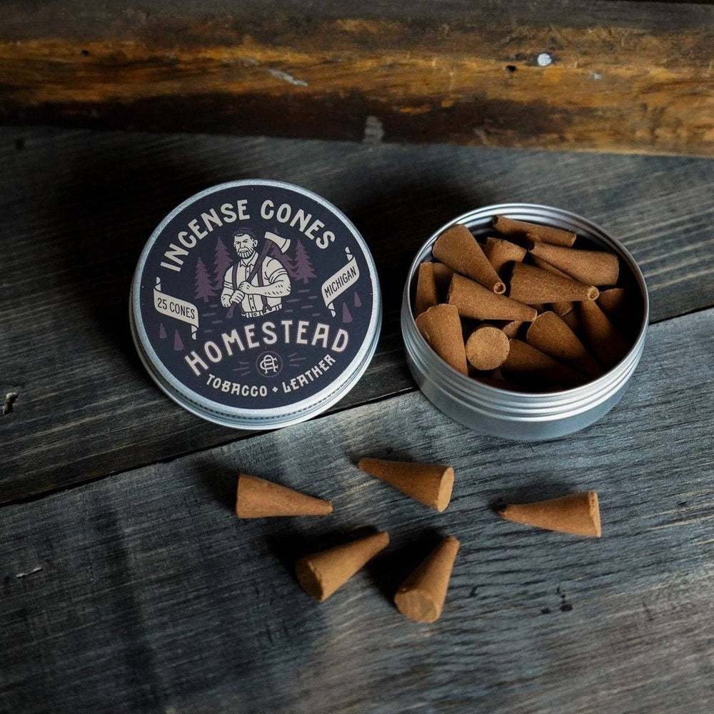 
                  
                    Incense cones in a tin with a label on a wooden surface
                  
                