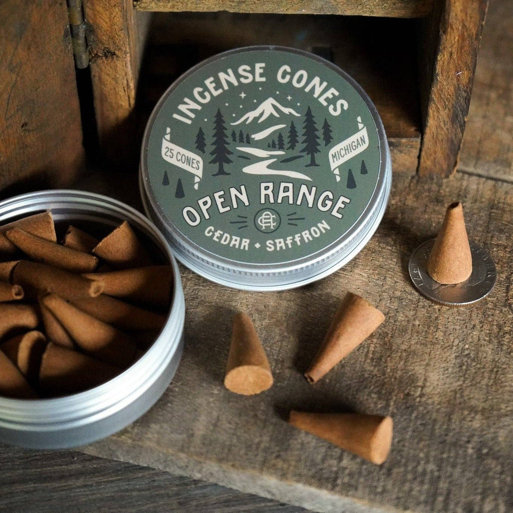 Incense cones with a container on a wooden surface