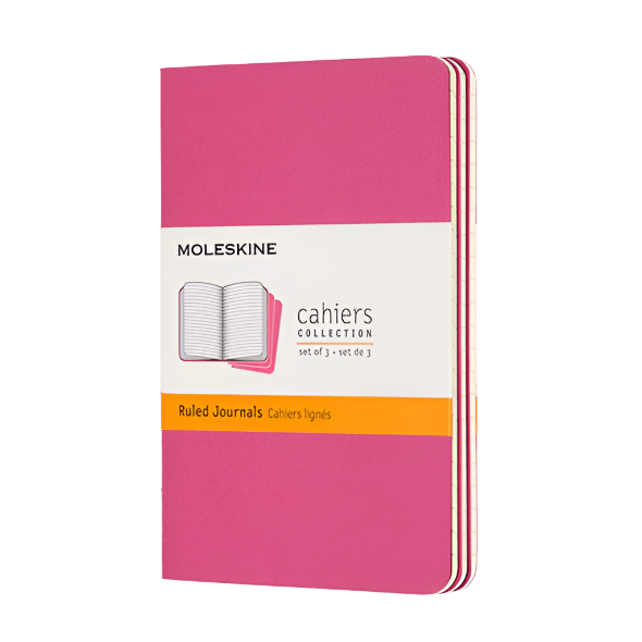 Pink Moleskine notebook with a white label on a white background