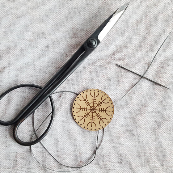 The Aegishjalmur Patch with pre-cut stitch holes ready to be sewed.