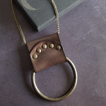  The antique red Lunar Necklace is a beautiful nod to the phases of the moon, hand dyed leather riveted around a solid metal ring lends a little ruggedness to your outfit. A lunar jewelry by Hord.