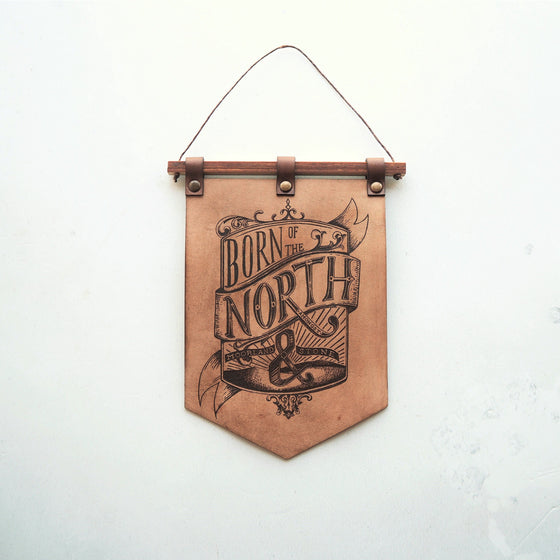 Full view of the Born of the North banner, crafted using luxurious leather for your home. A leather decoration from Hord.