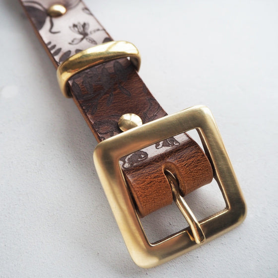 This designer leather belt, the botanical leather belt comes with solid brass hardware.