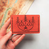 Campfire Card Holder has been engraved with an illustration of a campfire, trees and tents.