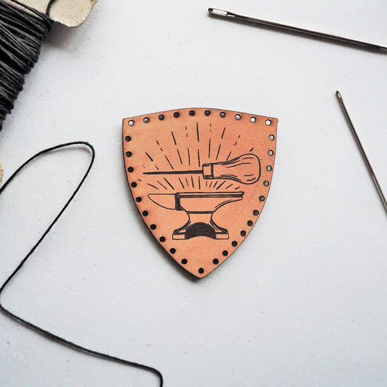 Craft Leather Patch, an art partch by HORD - This patch is hand dyed and engraved with our illustration of an anvil and awl, these patches are perfect stocking fillers for those who love to craft and make things by hand.
