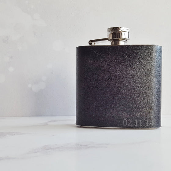 This black leather hip flask is personalised on the bottom right corner with a name, date, or initial of your choice.