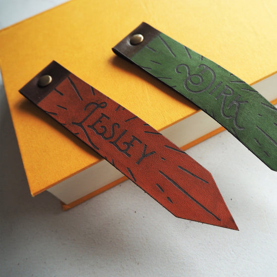Two Custom Leather Bookmarks from Hôrd which are hand dyed in green and medium brown leather colour.