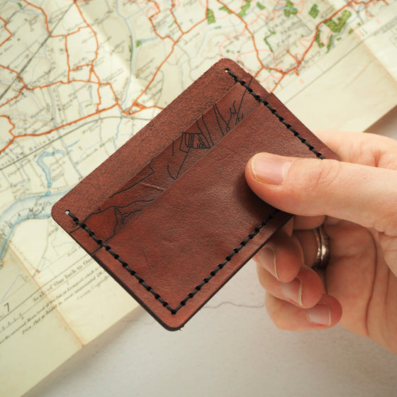 This luxury leather card holder from Hord features a custom road map engraved.