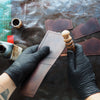 The Custom Topography Slim Mountain Wallet being expertly handcrafted at our studio.