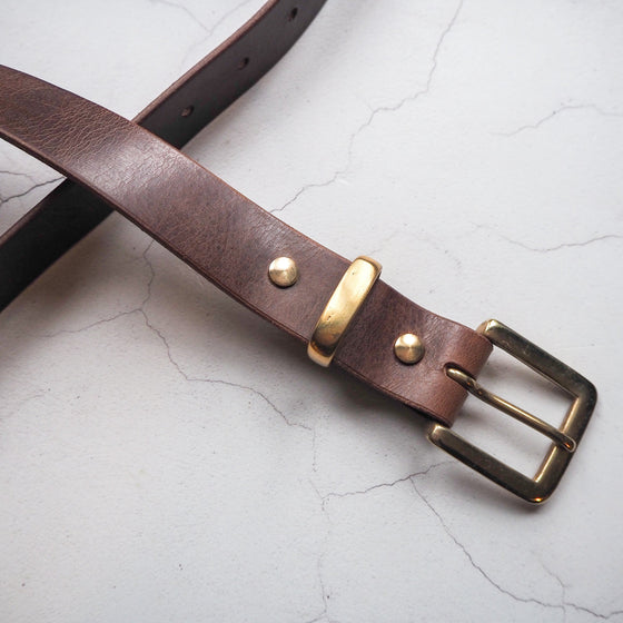 The leather belt with secret message in dark brown leather colour.