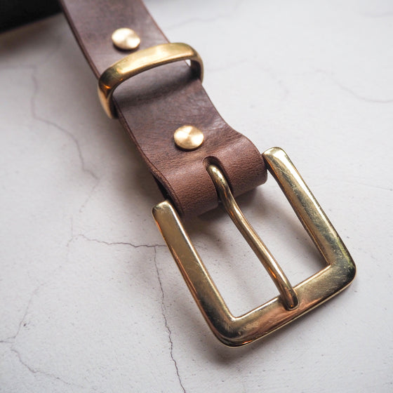This Dark Brown leather belt has been handcrafted using full grain leather and uses a solid brass hardware.