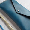 The Dyed Leather Pencil Case fastened with a stud.
