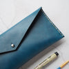 The Dyed Leather Pencil Case has been hand stitched with waxed white stitch colour.