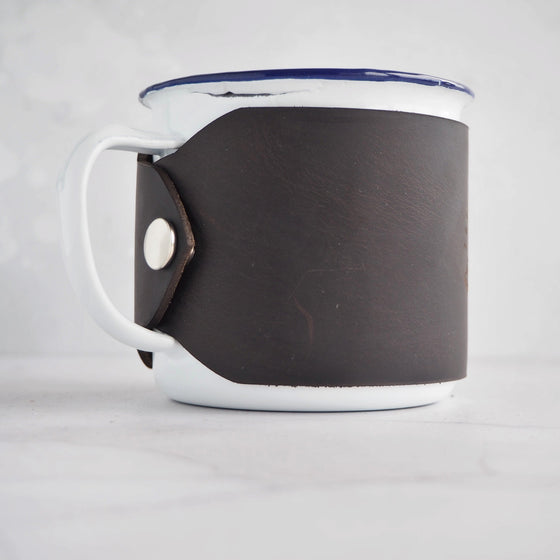 The Mountains Are Calling Enamel Mug from HÔRD is handcrafted from luxurious soft leather.
