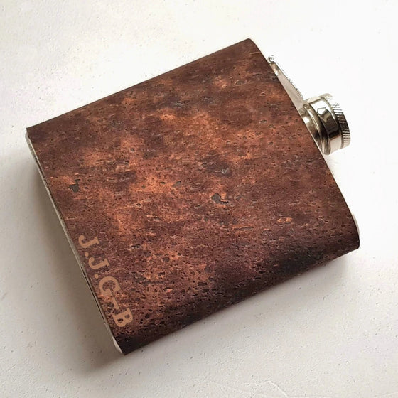 This initial hip flask is made from cork and clad onto a stainless steel hip flask.