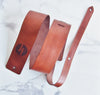 Full view of the Custom Leather Guitar Strap with A Custom Musician's Logo in CHestnut Brown Leather Colour by HÔRD.