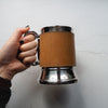 This leather tankard is made from luxurious leather that has been bound onto an insulated steel tankard.