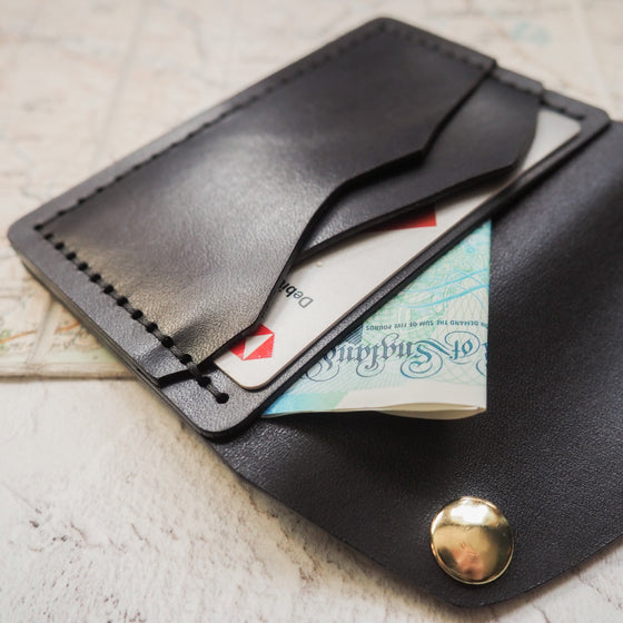The Minimalist Wallet hand dyed in black leather colour and hand stitched with double waxed black linen thread. 