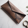 The Moth Leather Pencil Case that has been fastened with a Sam Browne stud.