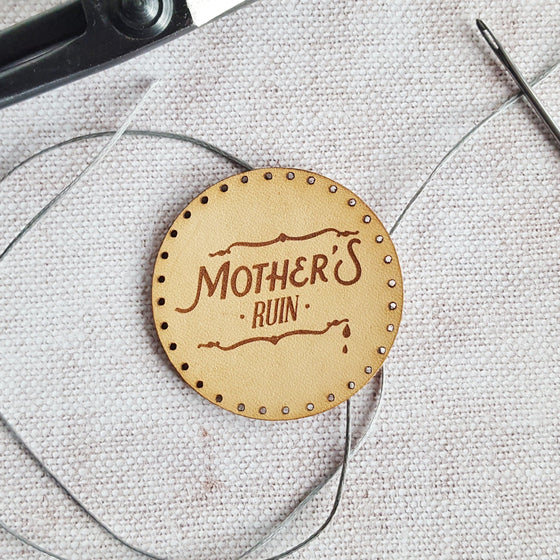 A circular natural leather patch engraved with 'Mother's Ruin' - perfect for gin lovers who like to fill their flask with glorious juniper spirit. The Gin Patch from Hord.