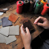 The Vertical Mountain Card Holder being hand stitched at our studio. 