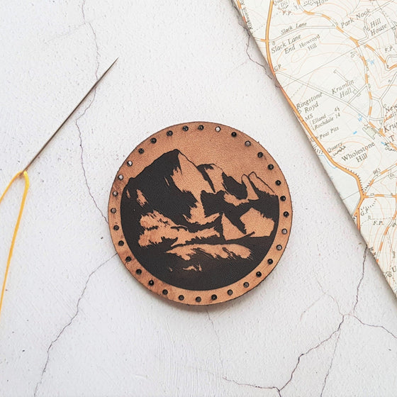 The Explorer Patch by HORD - This leather patch is hand dyed and engraved with wonderful mountains. Perfect stocking fillers or gifts for lovers of the outdoors, mountaineering and hiking.