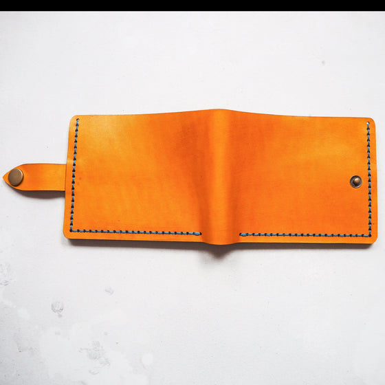 A hand dyed and hand stitched leather wallet, the mountain wallet with clasp from Hord.