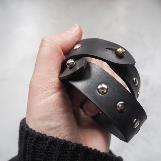 These studded bracelets are made in black leather colour.