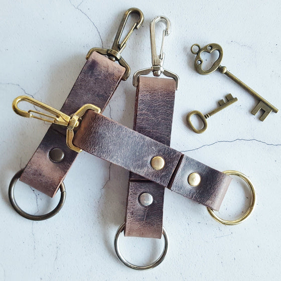 The Personalised Chunky Key Fob featuring all three material choices; brass, nickel, and antique brass.