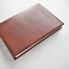 The Personalised Leather Notebook Cover A5 hand-dyed in medium brown leather colour and dark brown stitch colour.