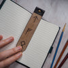 The personalised bookmark with runes on an A6 Moleskine Cahier.
