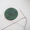 This vintage patch has been engraved with a custom initial.