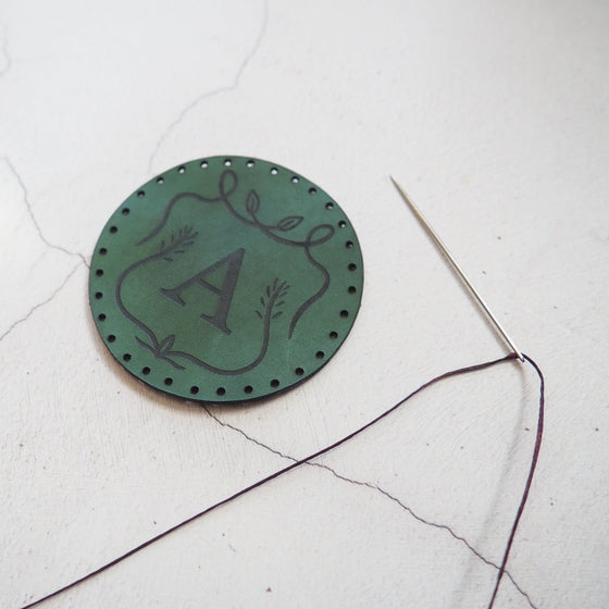 This vintage patch has been engraved with a custom initial.