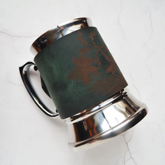 This personalised pint tankard is engraved with our signature botanical design.