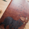 The Bear & Butterfly engraved leather notebook by HÔRD with the clasp tightened.