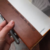 Internal engraved quote on a leather journal cover, by Hord