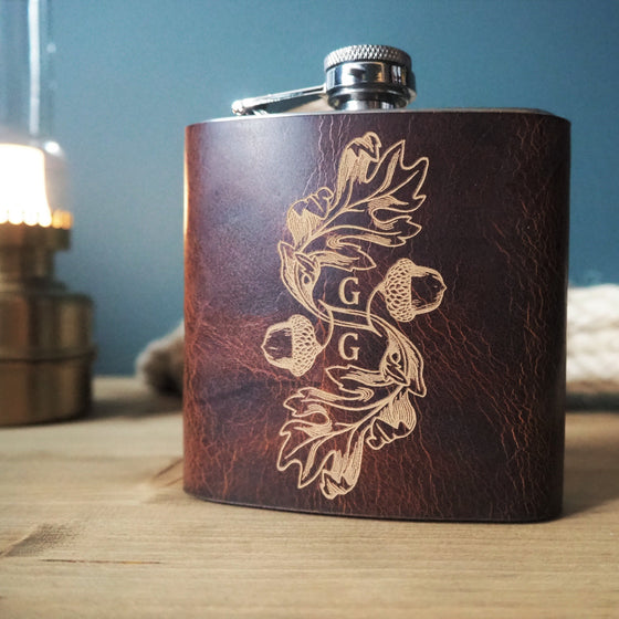 This monogram leather flask is hand dyed and clad onto a stainless steel hip flask.