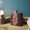 The Acorn & Leaf Monogram Hip Flask, a monogram leather flask from Hord.