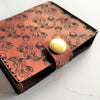 Acorn illustration engraved onto a leather playing card case by HÔRD.