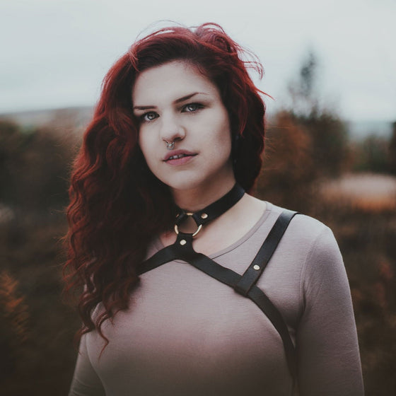 This modular leather shoulder harness is perfect for adding some rugged detail to your outfits, celebrating your inner shield maiden. Made from genuine leather and brass. By Hord.