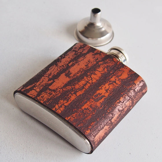 This personalized engraved flask is hand dyed and comes with a funnel.