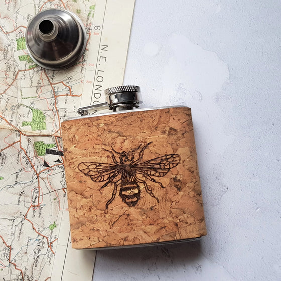 This a custom liquor flask has been made from cork and engraved with our bee design.